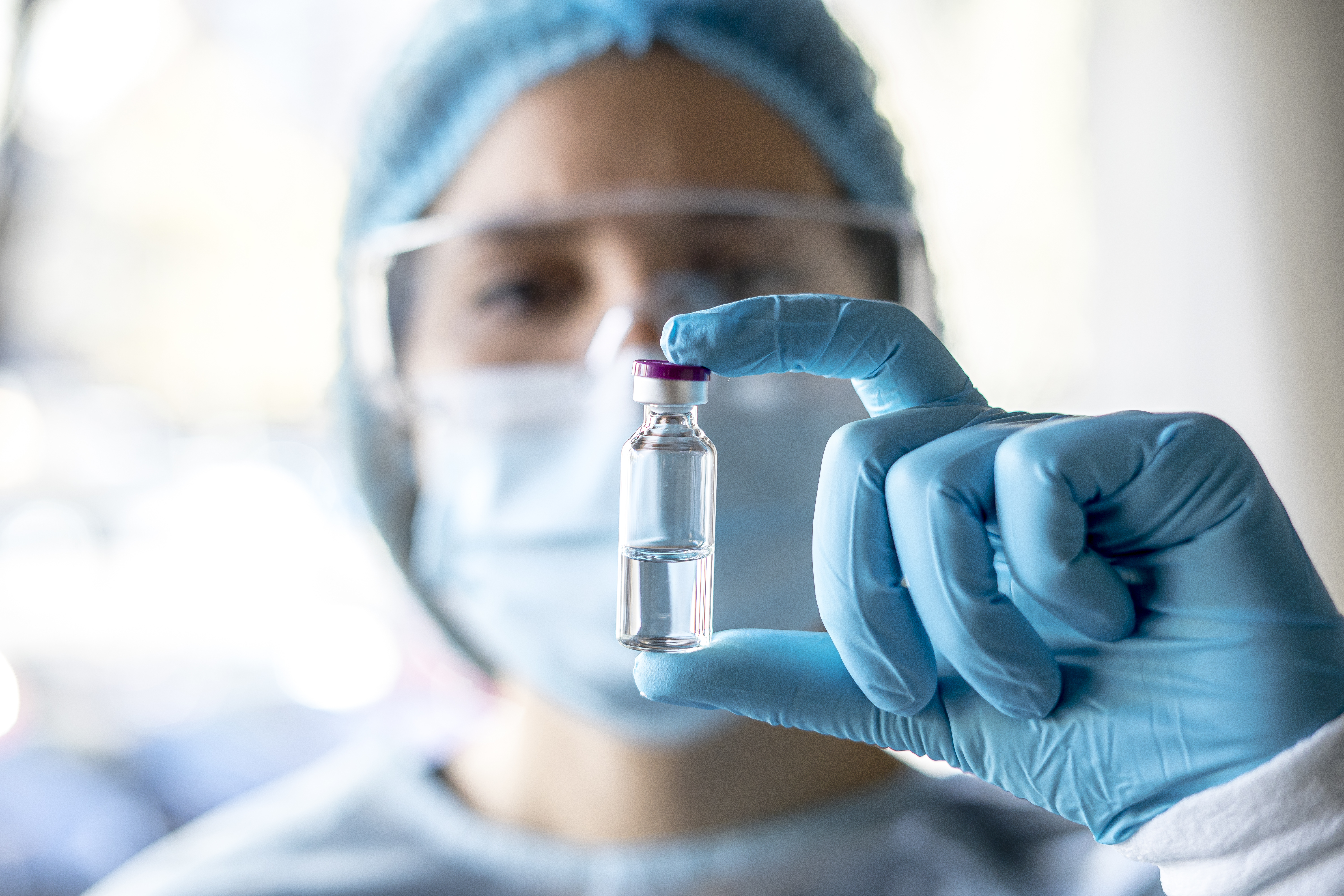 Medical doctor or laborant holding tube with nCoV Coronavirus vaccine for 2019-nCoV virus